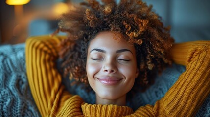 Fototapeta premium A woman with curly hair relaxing on a couch