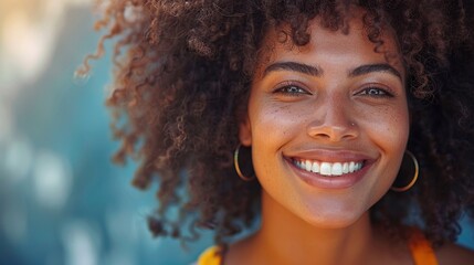 Close-up of a woman with curly hair smiling happily - obrazy, fototapety, plakaty