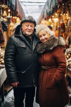 A happy couple poses for a picture in a winter jacket and hat.