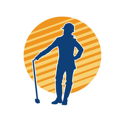 Obraz premium Silhouette of a woman in worker costume carrying pick axe tool in action pose. Silhouette of a female miner in action pose with pick axe tool.