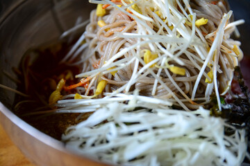 Close-up of "memil naengmyeon", a Korean-styled buckwheat cold noodle in a bowl