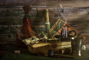 On the table are antique nautical maps, a box, a leather-wrapped bottle and a metal goblet, a...
