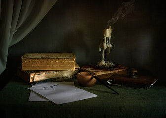 Unfinished letter. The extinguished candle is still smoking. pen with feather and inkwell. Vintage.