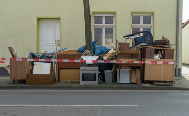 Pile of bulky waste with furniture and electrical appliances on the side of the road