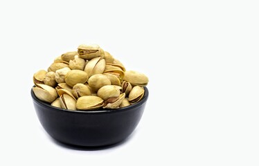 Pistachio Nut Dried Fruit in Black Bowl Isolated on White Background in Horizontal Orientation with Copy Space, Healthy Eating and Lifestyle Food Concepts