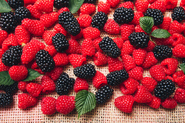 background sweet raspberries and blackberries - delicious mix close up