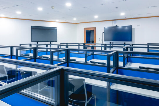 Empty college classroom featuring contemporary design with interactive displays and tiered seating arrangements.