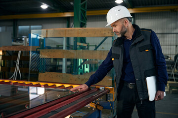 Man with a laptop inspects the material for double-glazed windows