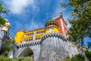 Low angle view of the fortified walls of the Pena Palace in a colorful yellow and red style on...