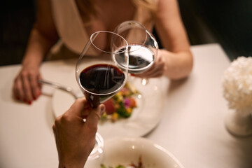Couple enjoying red wine during dinner in a restaurant