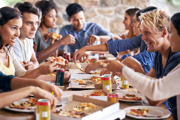Group, friends and party with pizza, celebration and diversity for joy or fun with youth. Men, women and fast food with drink, social gathering and snack for lunch or eating at italian pizzeria