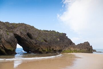 Fototapeta na wymiar Rock arch on San Antolin beach, Spain