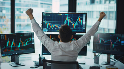 Euphoric businessman celebrates a stock market victory in front of monitors. - obrazy, fototapety, plakaty