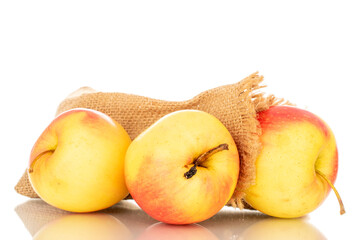 Three yellow apples with jute bag, macro, isolated on white background.