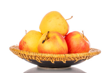 Several yellow apples on a ceramic plate, macro, isolated on a white background.