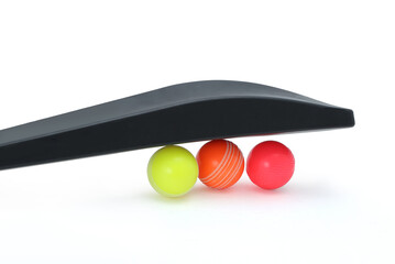 wind ball with black pvc cricket bat isolated 