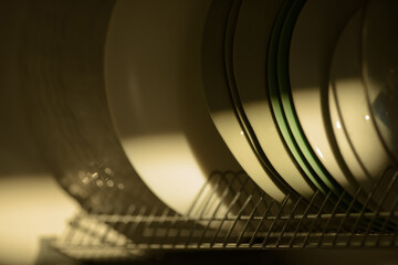 kitchen shelf with clean dishes illuminated by the morning sun ray