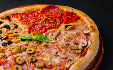 Appetizing pizza with bacon, salami, ham and pepperoni