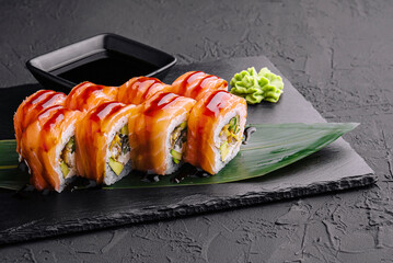 Delicious philadelphia sushi on black stone plate