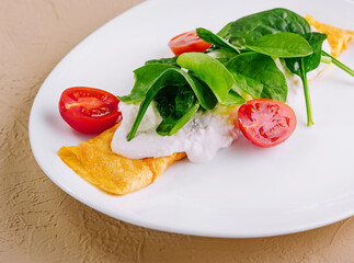 Omelet with tomatoes and herbs on a plate