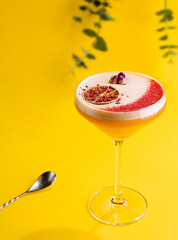 tropical cocktail on yellow background top view