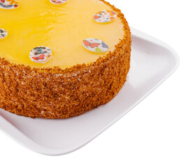 Carrot cake in yellow glaze on plate