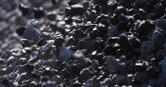 Super slow motion macro of falling gravel stones on ground during quality control and sorting process at concrete plant industrial factory at 1000 fps.