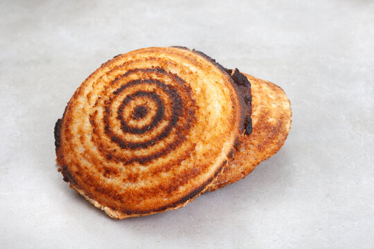Jaffle, an old school toasted sandwich, filled with savory mince. Grey backdrop, copy space
