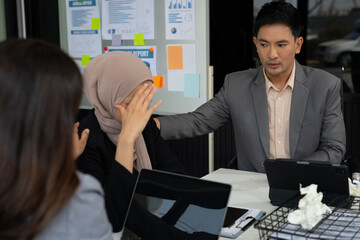 Teamwork, people and crisis concept - business team sitting sad and solving problems in the office.