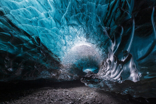 Beautiful blue glacial ice cave in spiral shape in Vatnajokull National Park in Iceland