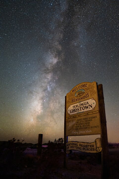 Wooden welcome singn of Terlingua ghost town in Texas, USA on the mexican border with the Milky Way on the night sky