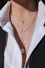 Beautiful female neck with jewelry and accessories chain with a cross, close-up. Women's jewelry