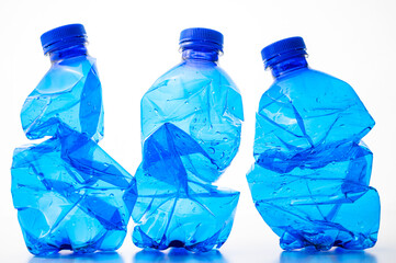Plastic bottles, blue and transparent, crushed. Waste and plastic pollution, plastic recycling. 

