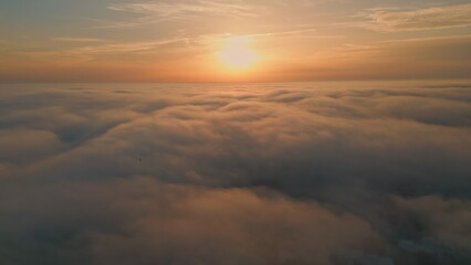 Orange sunrise shining clouds aerial view. Thick fog covering picturesque nature