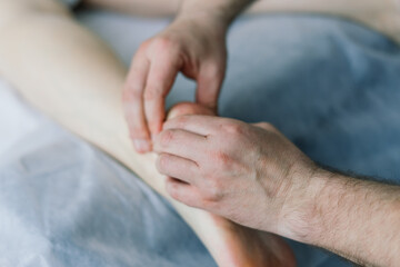 Young fat woman getting massage treatment in day spa cabinet.