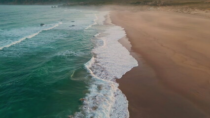 Sea water waves foaming sand closeup. Stormy ocean surf washing sandy beach