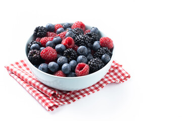 Fresh assortment berries in bowl isolated on white background. Copy space