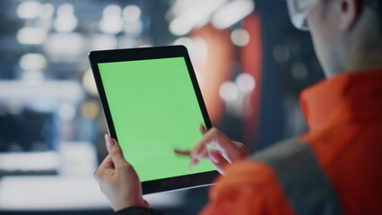 Engineer hands scrolling green screen tablet at production factory close up.