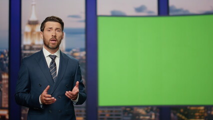 Elegant host reporting breaking news standing near green screen close up.