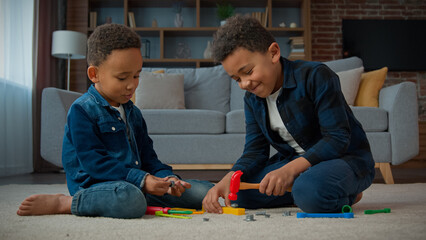 Two ethnic little boys African American multiracial kids schoolboys pupils children play game...