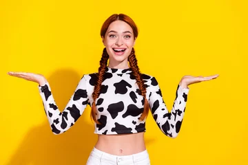 Deurstickers Photo of excited funky woman wear cow skin top plump lips showing arms scales empty space isolated yellow color background © deagreez