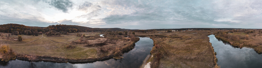 Aerial panorama on river curve in autumn valley
