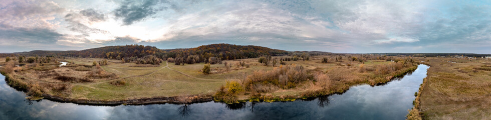 Aerial panorama on river curve in autumn valley