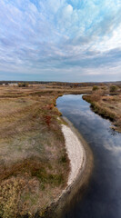 Aerial vertical panorama of river in autumn valley