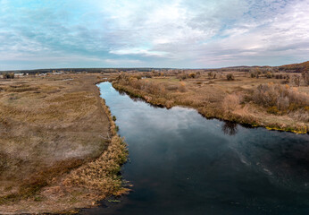 Aerial panorama on river curve in autumn colors