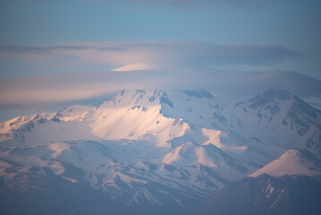 colorful snowy mountains distant shot at sunset time