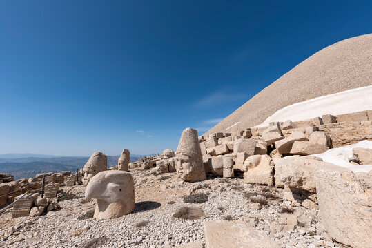Nemrut ancient ruins statue heads on top of the mountain snowy day blue sky stars at night