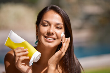 Woman, swimming pool and sunscreen protection on face or summer weekend or tanning, holiday or...