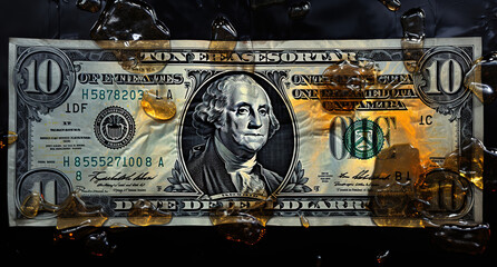 A dollar bill caught in a dynamic splash of amber liquid, concept of financial flow. - obrazy, fototapety, plakaty
