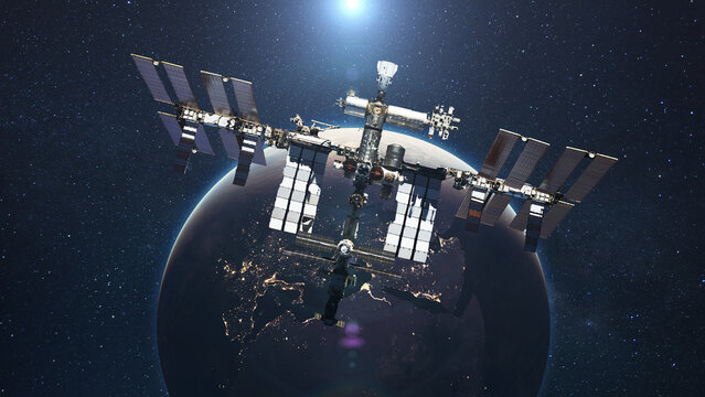 The ISS flies on the background of the blue planet Earth with the light of the sun. Space mission and space exploration
